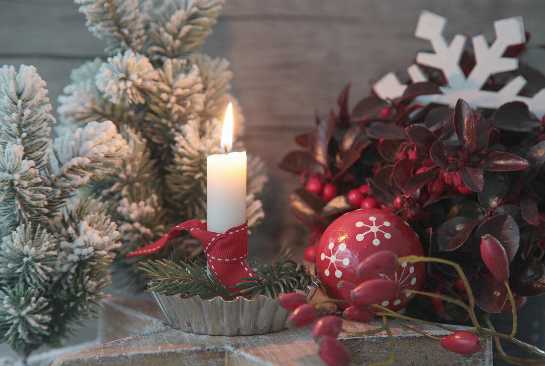 Candle in flan tin on a wooden star, Christmas tree bauble, tiny Christmas tree and rose hips