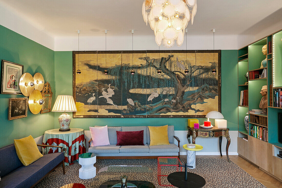 Sitzmöbel und großformatiges Kunstwerk im Salon mit grünen Wänden