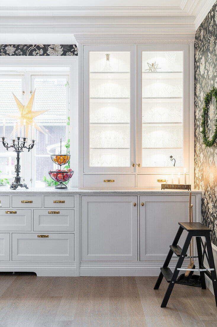 White kitchen counter, Christmas decoration on the window