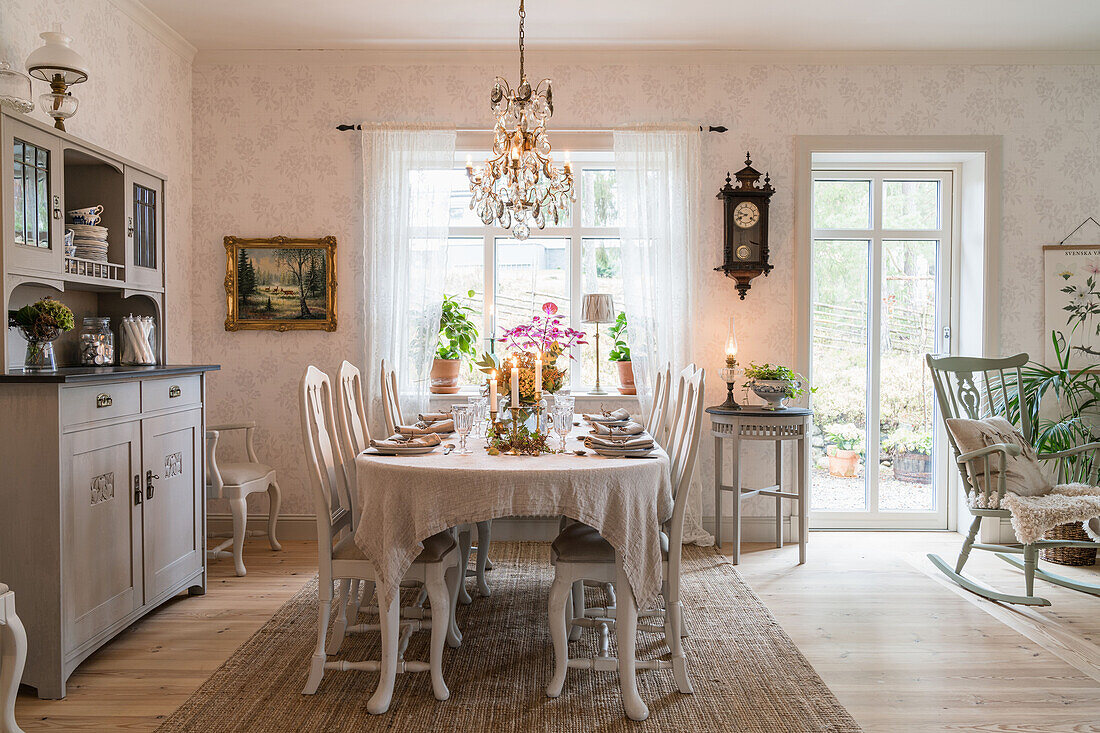 Dining area with set table and sideboard in country style