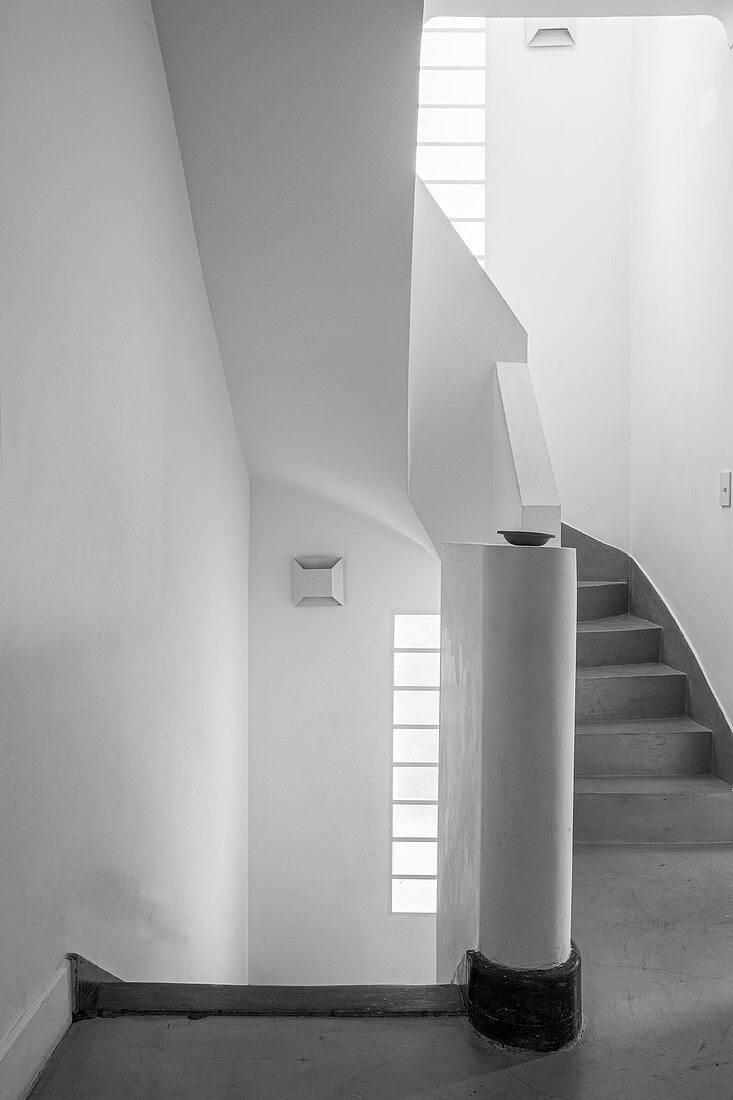 White stairwell with grey spiral staircase