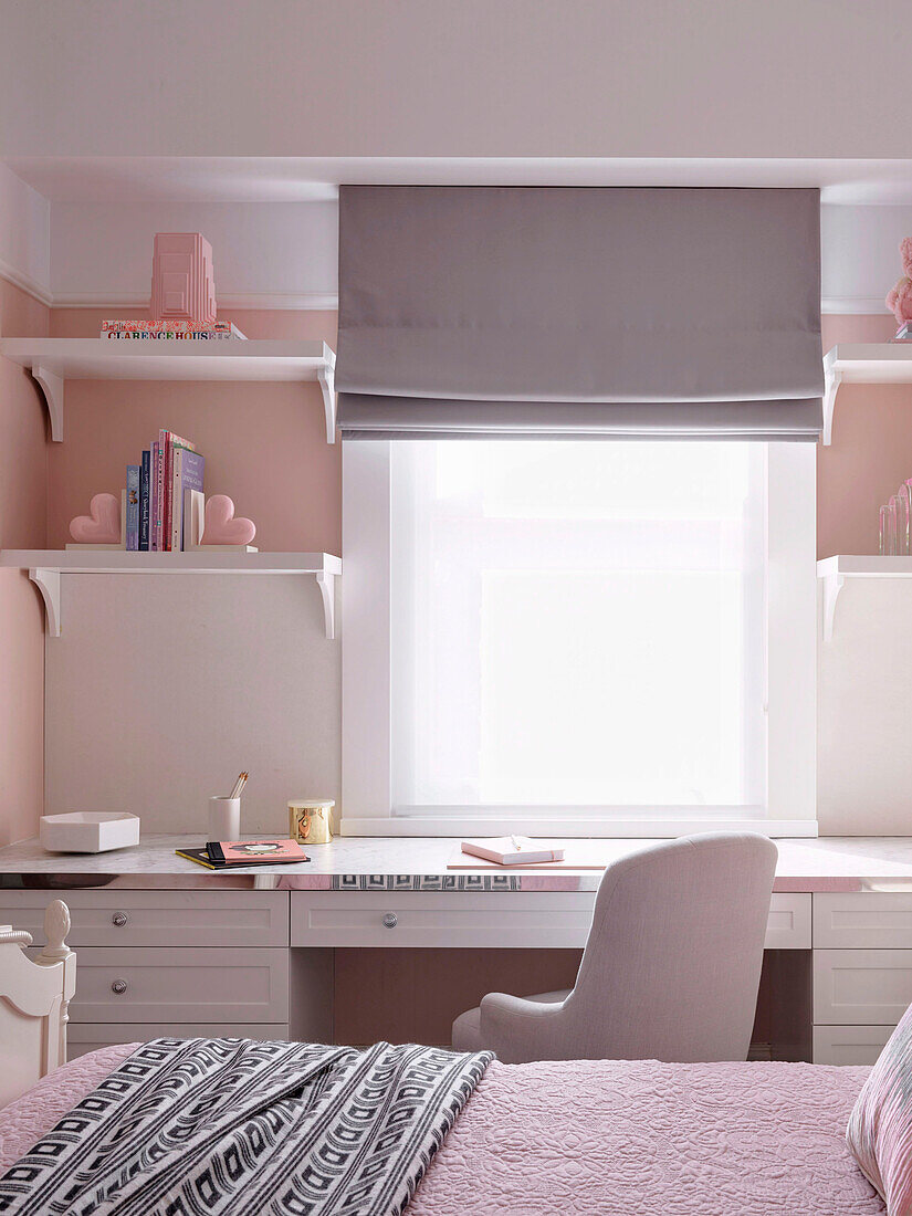 Girl's room in white and pink tones with desk in front of the window