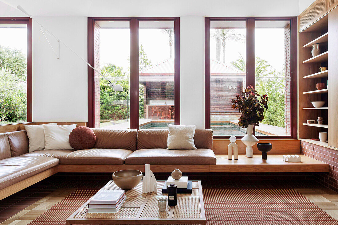 Built-in sofa and coffee table in front of floor-to-ceiling windows