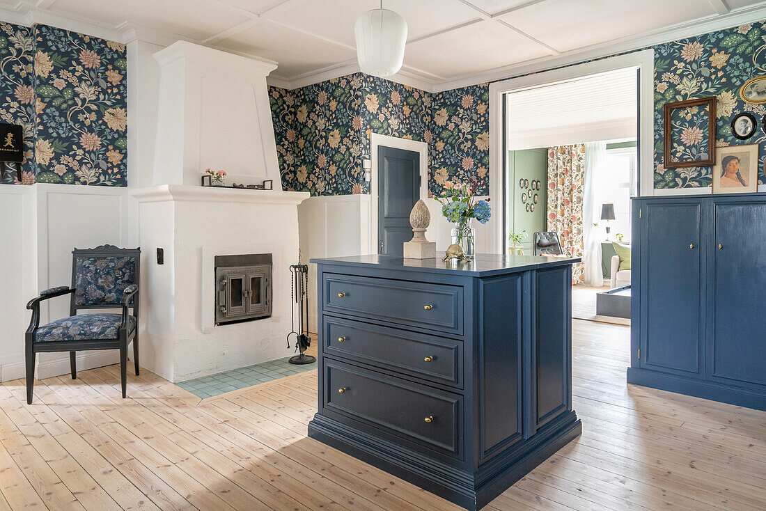Swedish-style hallway in blue and white with fireplace and floral wallpaper
