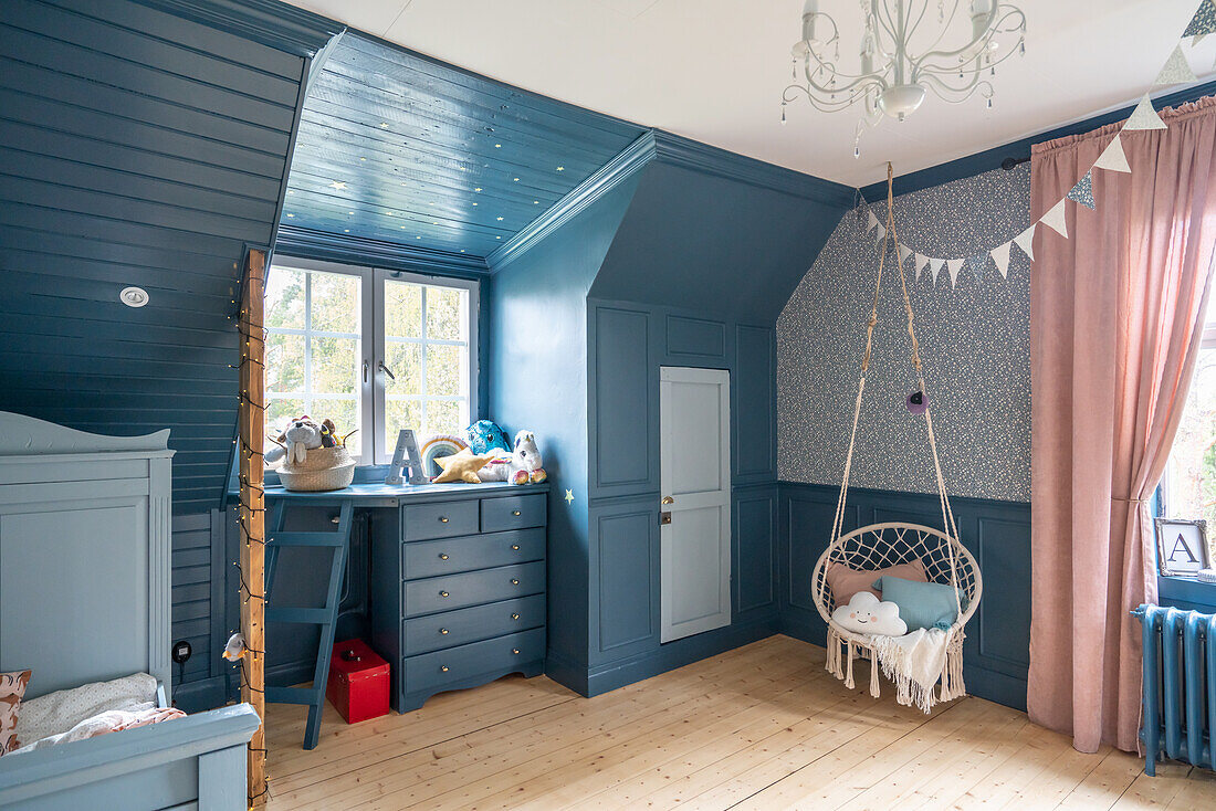 Large children's room in a vintage style with blue wall paneling