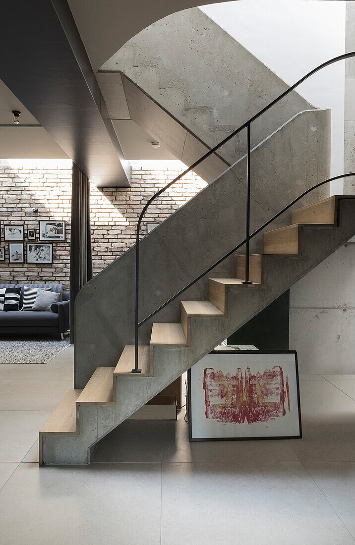 Concrete staircase with wooden panelling in a loft apartment