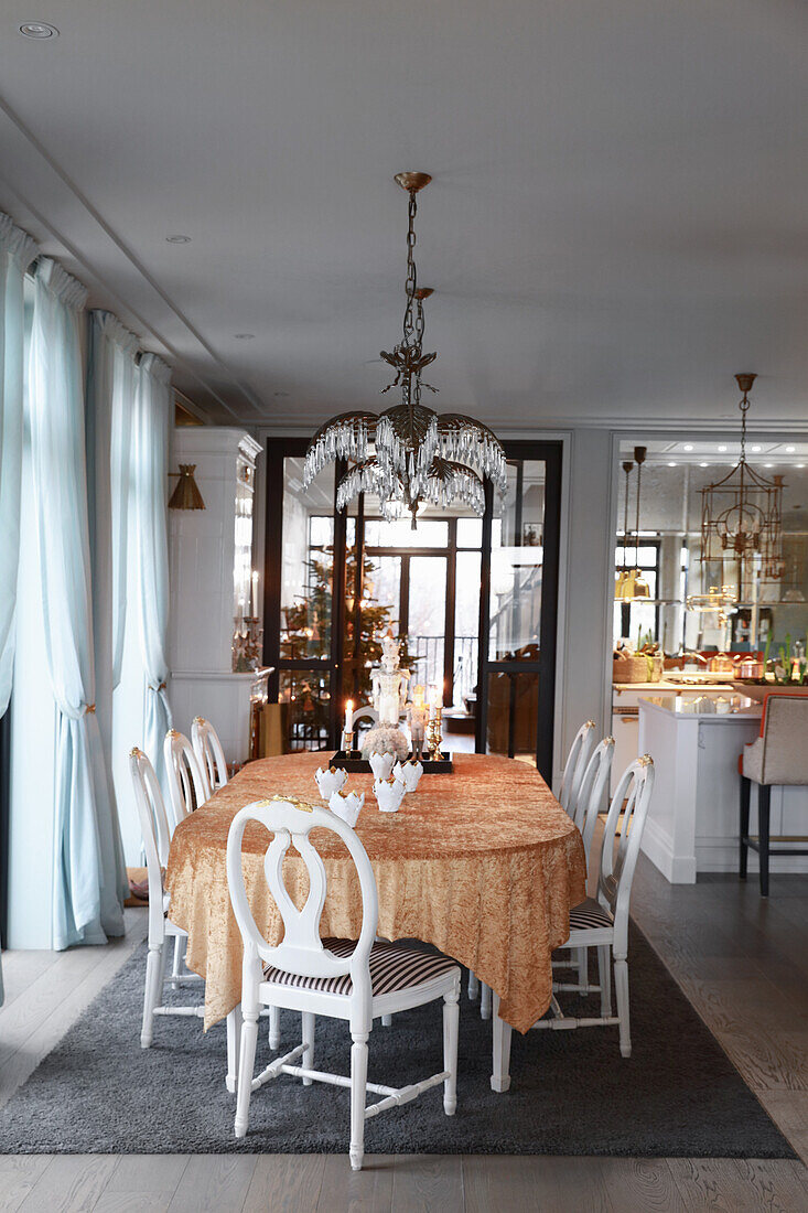 Elegant dining area with Christmas decorations and designer lamp