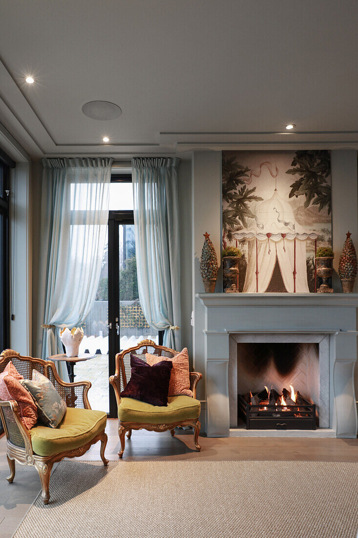 Seating area with two armchairs next to the fireplace