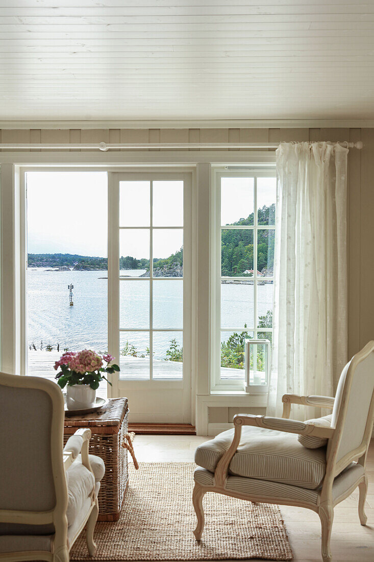 Gustavian upholstered chairs by patio doors with sea view