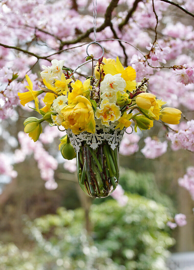 Hanging spring bouquet of daffodils, tulips and primrose