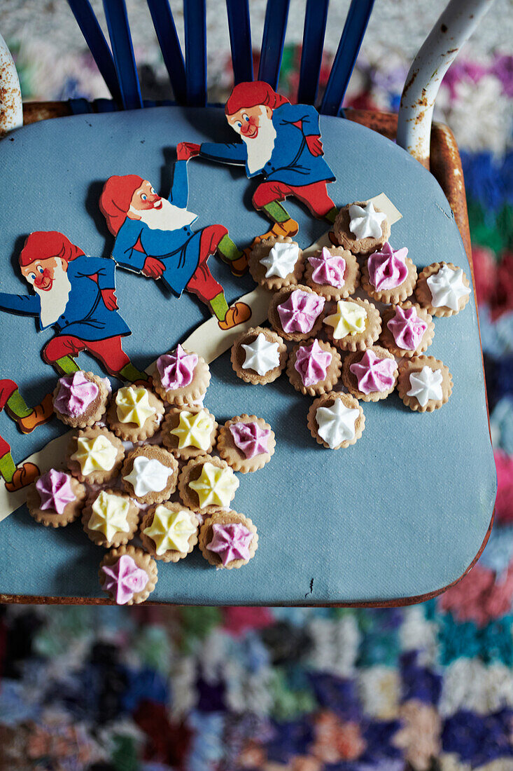 Dwarf figures and star-shaped cookies on blue chair seat