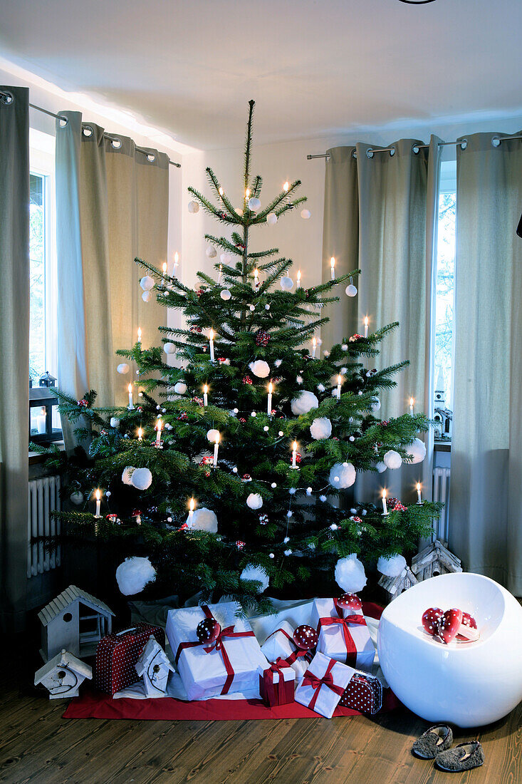 Christmas tree decorated with presents in the living room