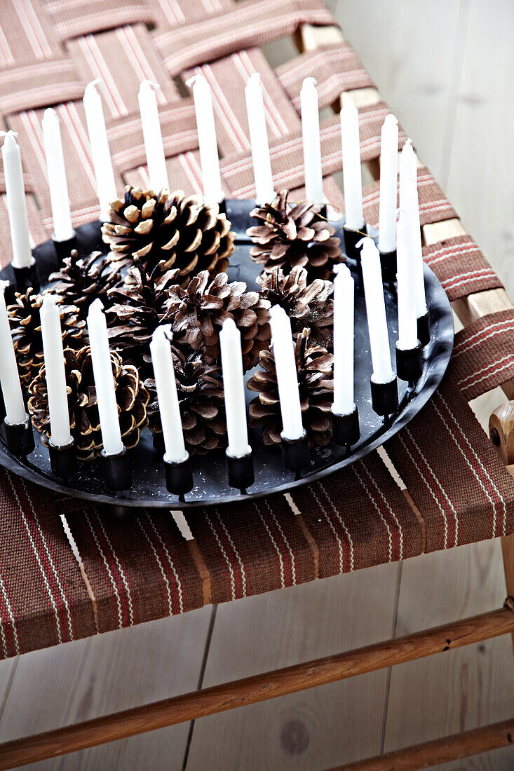 Wreath with lots of candles and pine cones