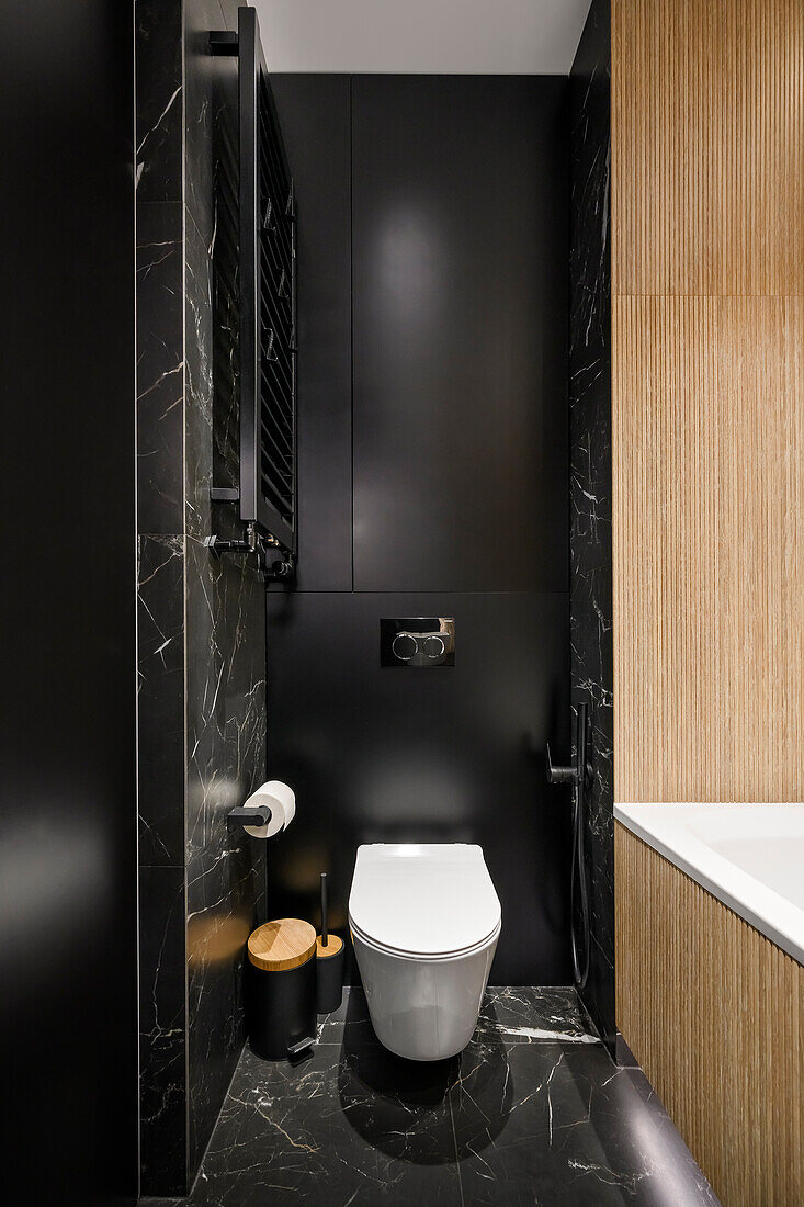 Small bathroom with wood paneling and black marble