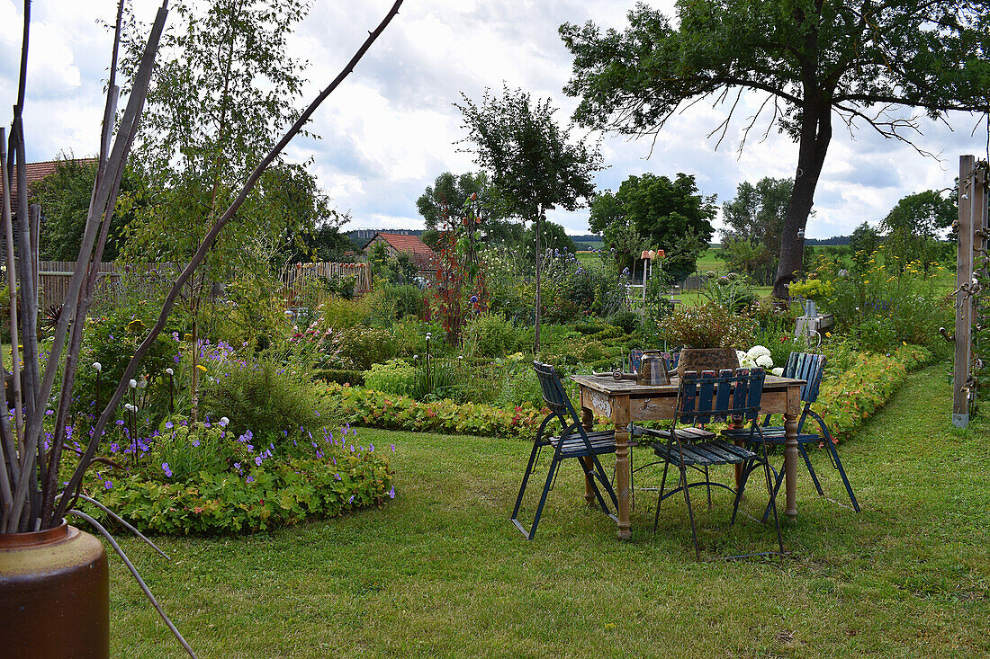 Late summer seating area in a cottage garden
