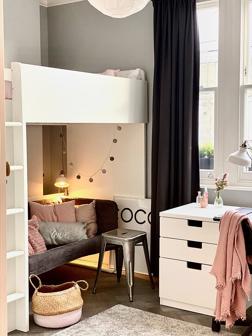 Loft bed with sofa, metal stool and drawer container in girl's bedroom