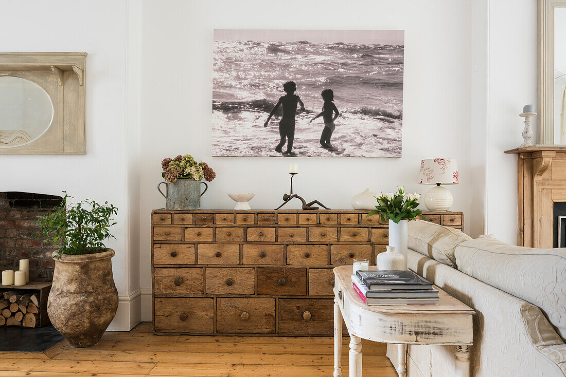 Living room with vintage wooden dresser and cosy fireplace