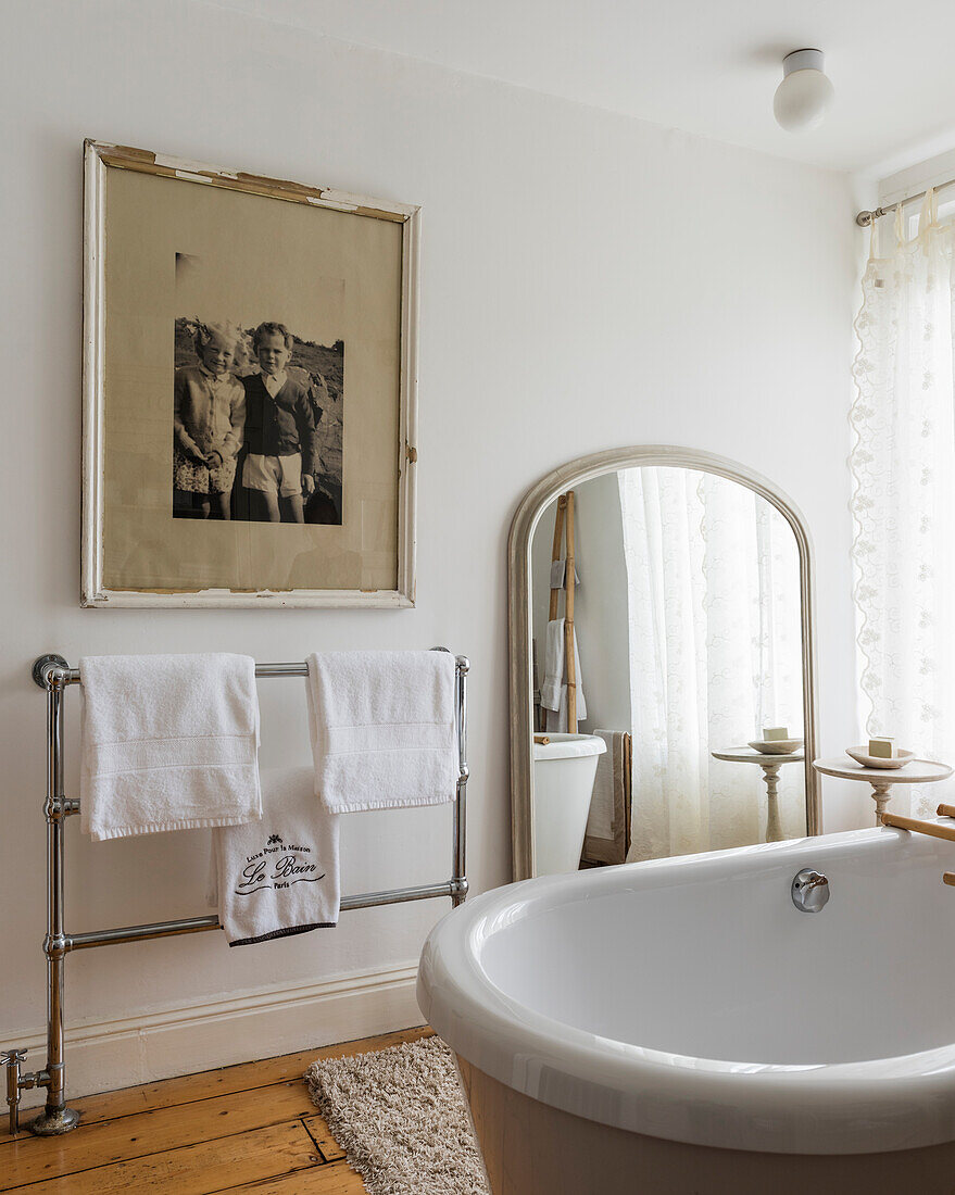 Vintage-style bathroom with freestanding bathtub and metal towel rail