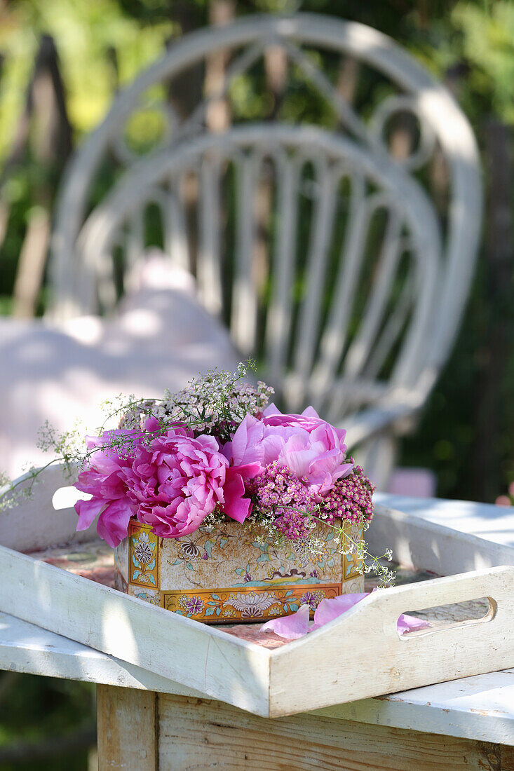 Peonies and heritage tree peonies in vintage tin jugs