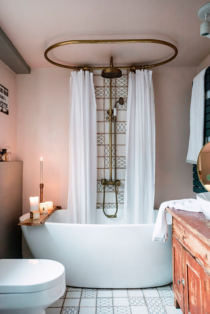 Bathroom with freestanding bathtub, vintage shower fitting and old wooden sink base