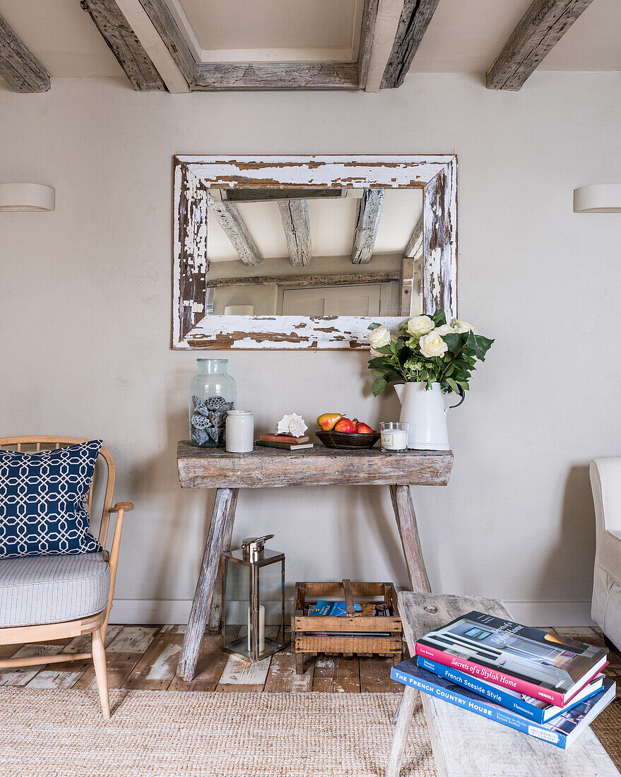 Rustic console table with decorations and vintage mirror in the living room