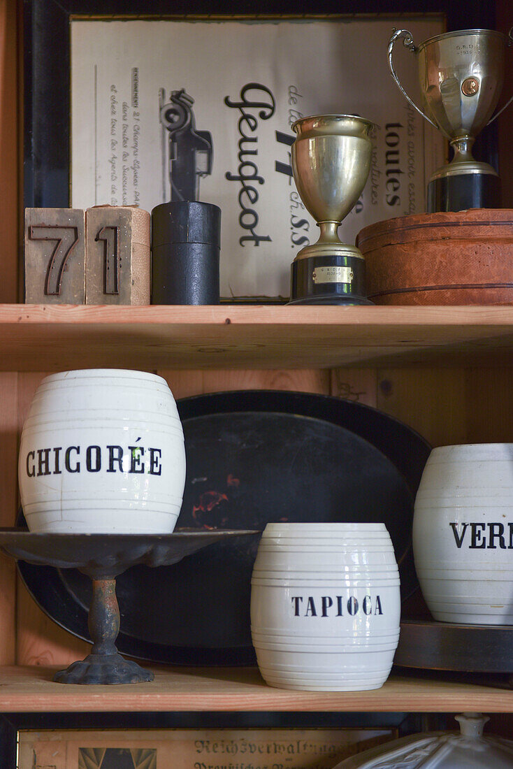 Beschriftete Keramikgefäße und antike Pokale im Schrank