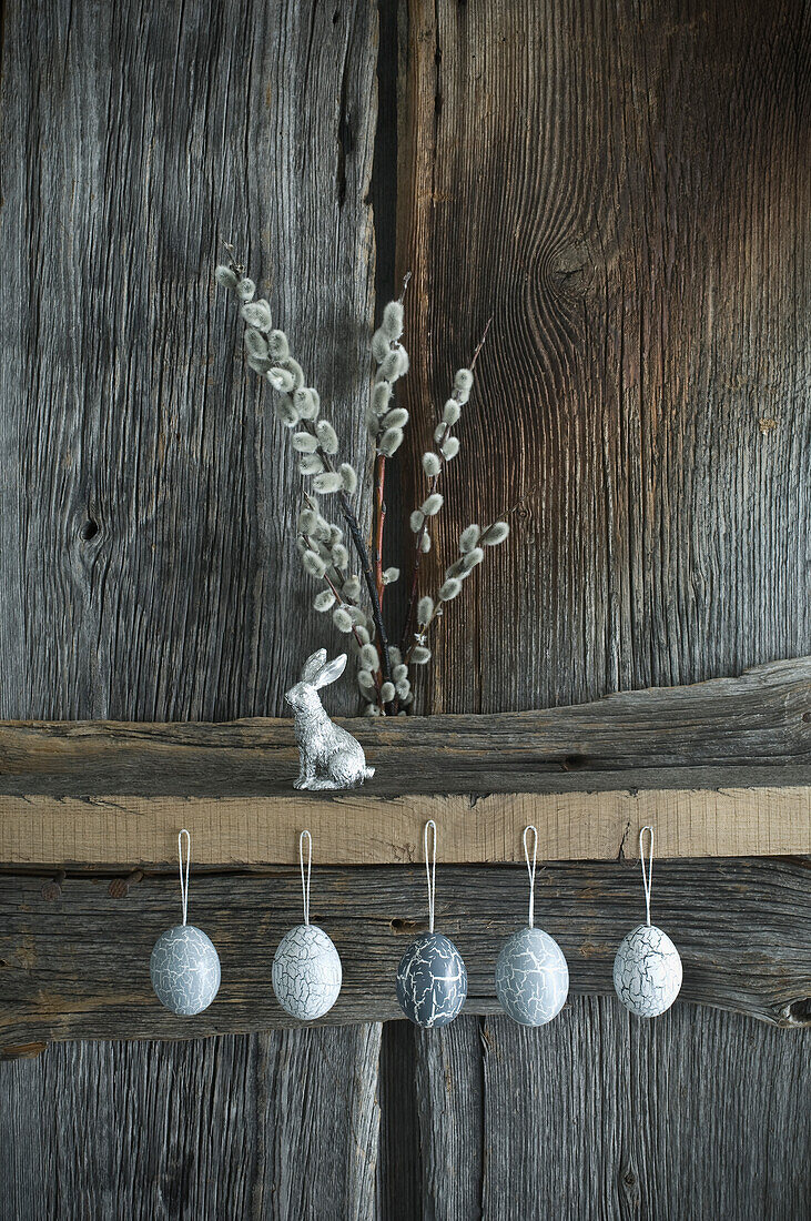 Hand-painted Easter eggs, willow twigs and a silver Easter bunny