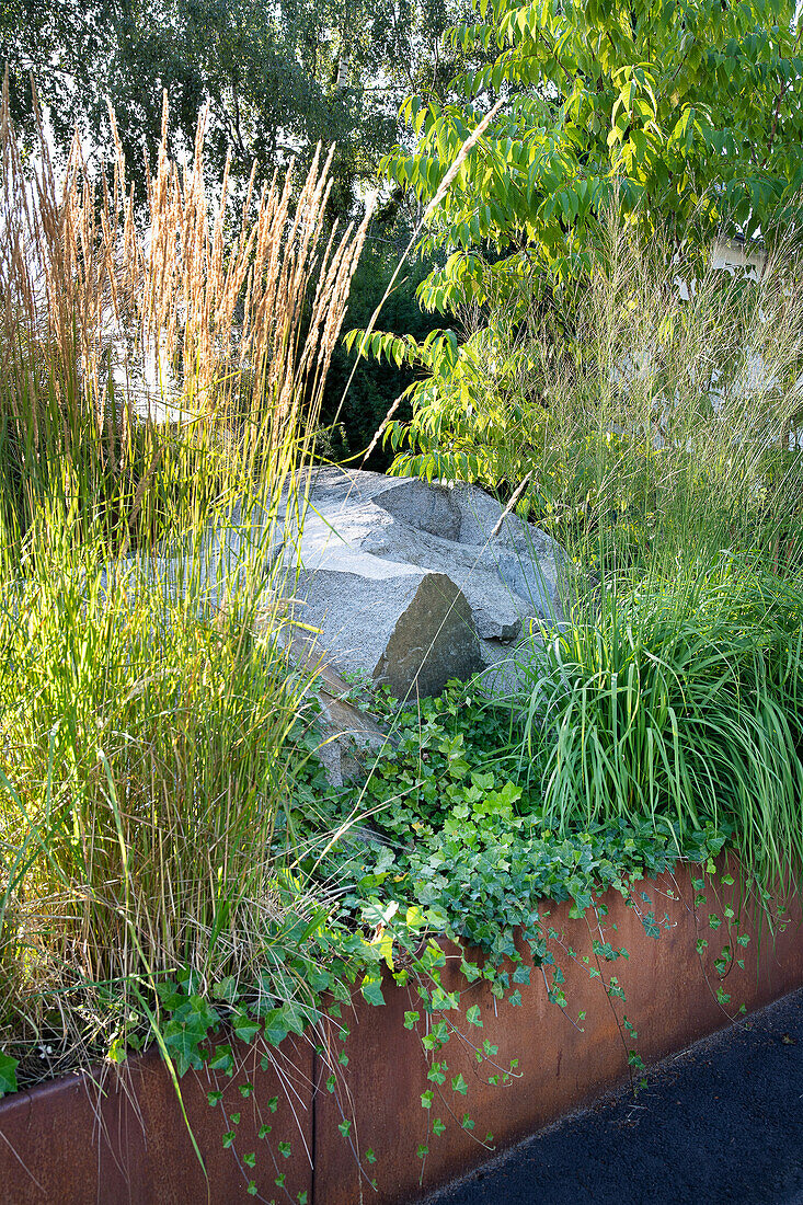 Planted bed with rocks and corten steel edging