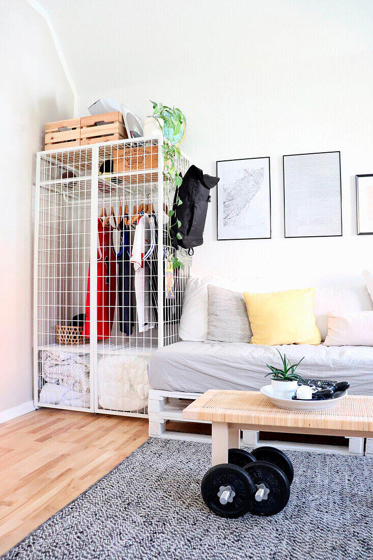 Simple bedroom with lattice wardrobe and dumbbells on a carpeted floor