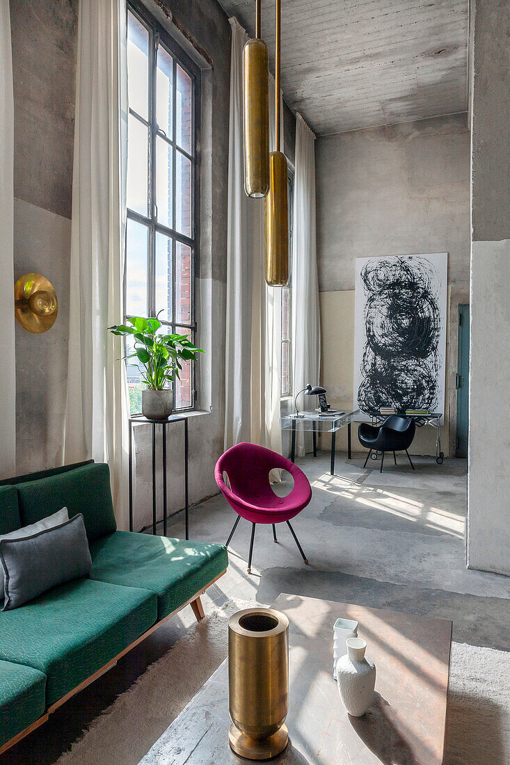 Modern loft living room with high ceilings, concrete look and colourful designer furniture