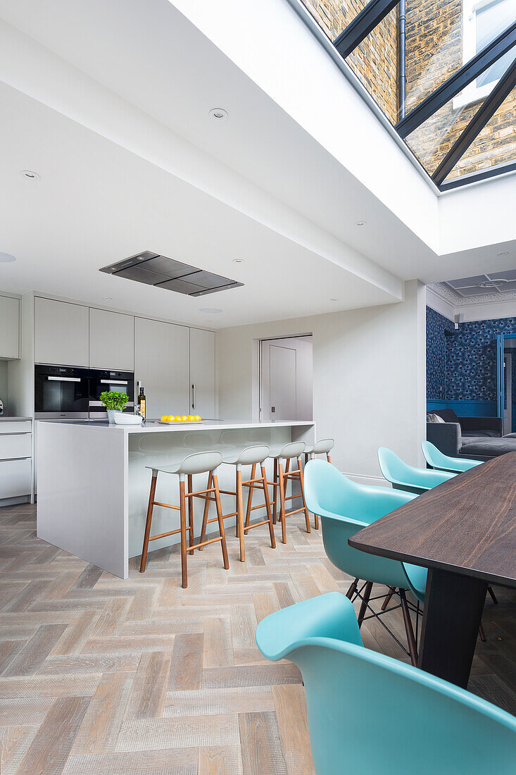 Modern kitchen with kitchen island, bar stools and skylight