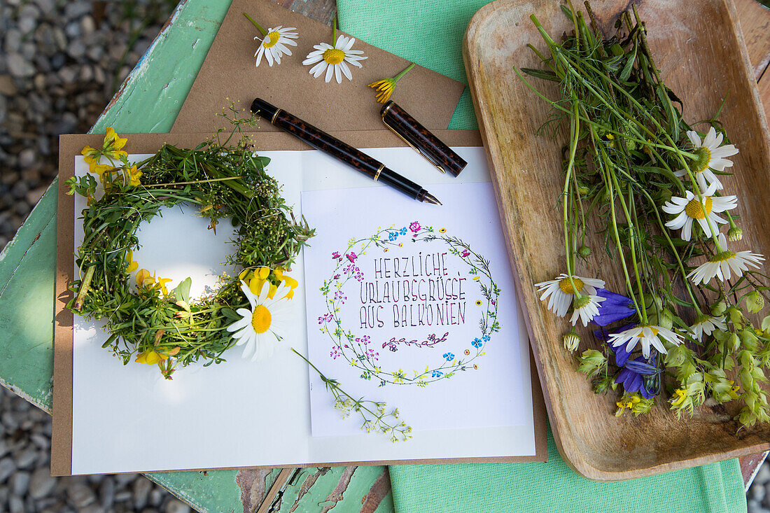 DIY greeting card with flower wreath and fresh wildflowers