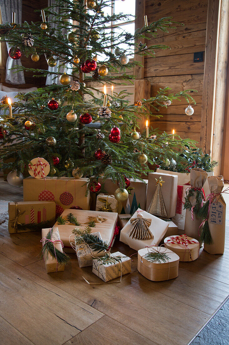 Christmas tree with red and gold baubles and presents