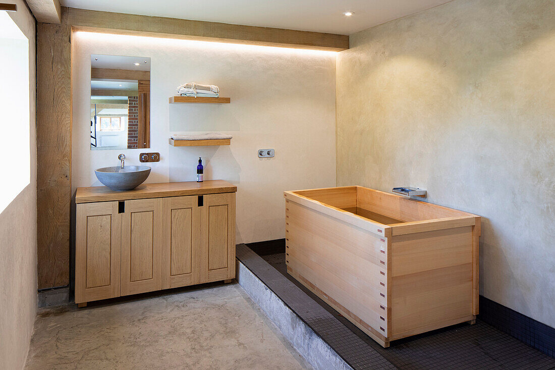 Rectangular wooden bathtub in minimalist bathroom