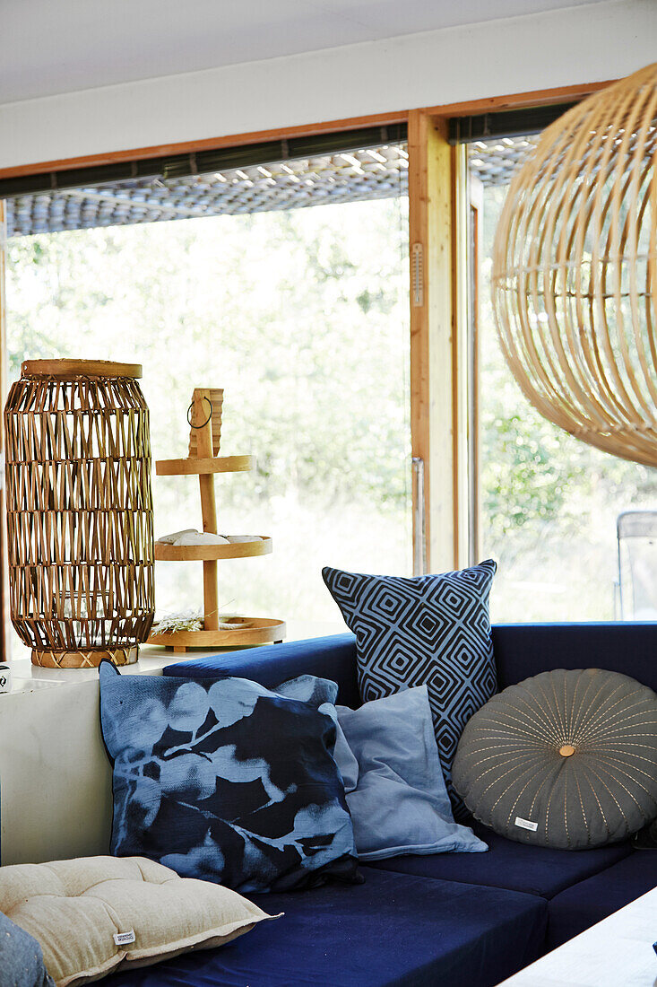 Blue sofa with cushions and bamboo lamp