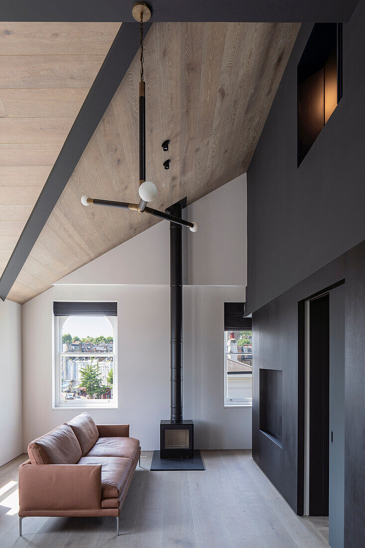 Minimalist living room with wood stove and leather sofa