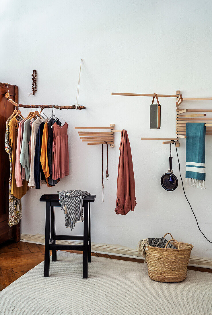 Trestle bench, towel rack and branch used as clothes rail