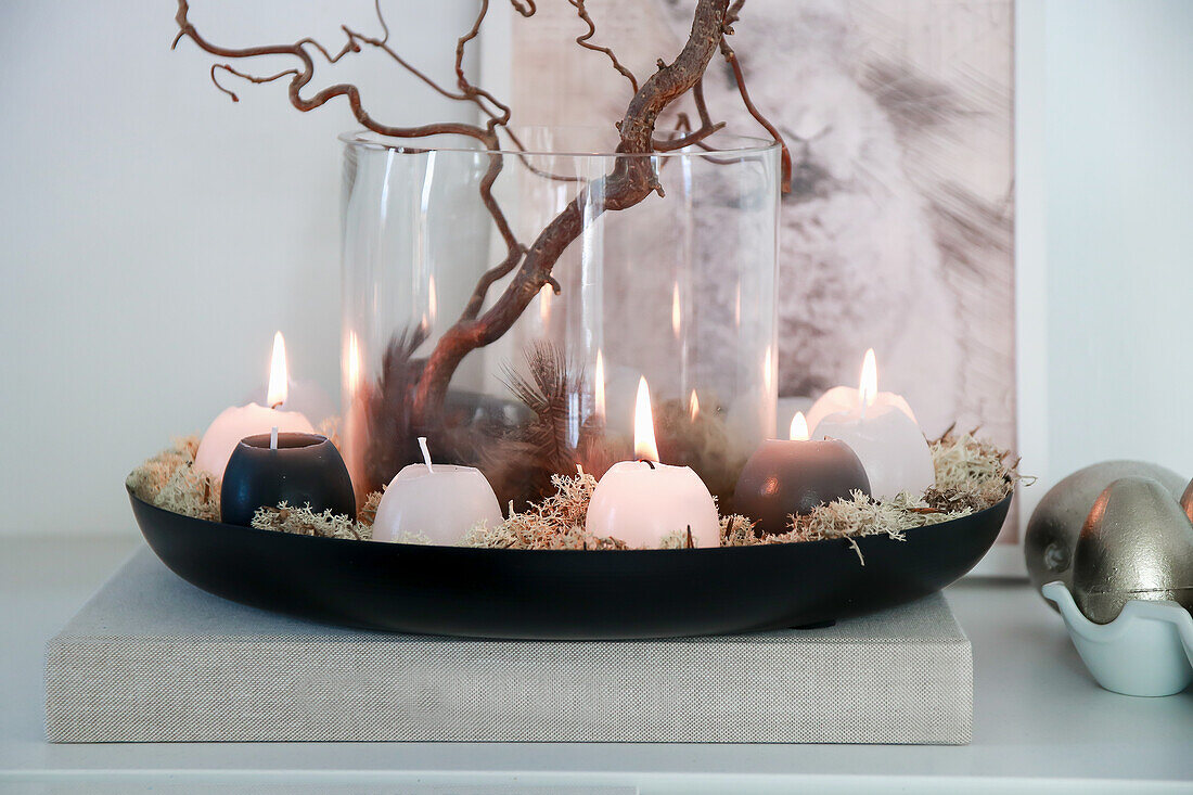 Candle arrangement with branches on sideboard