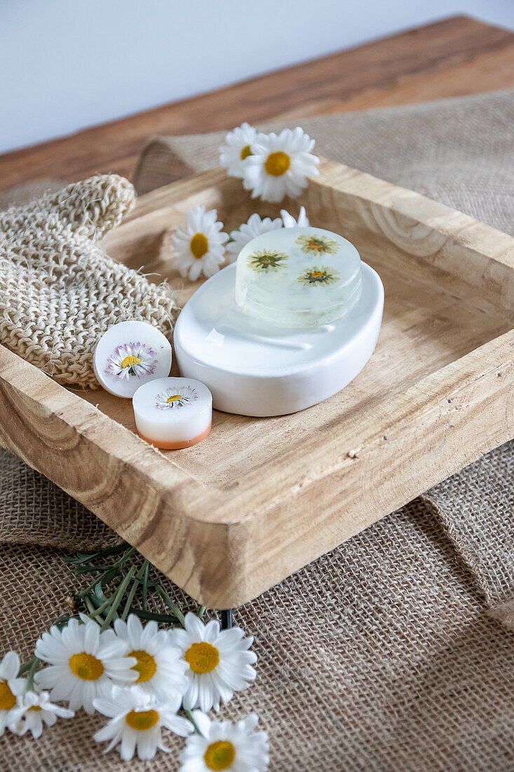 Handmade soaps with flowers on a wooden tray