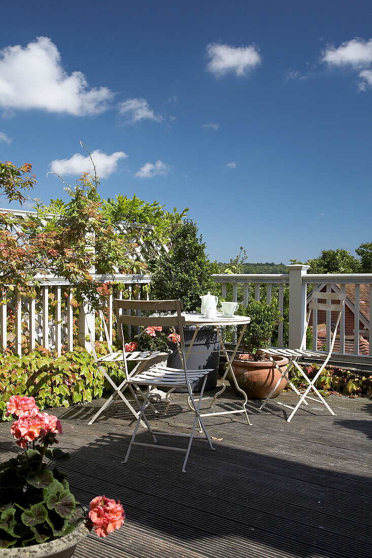 Folding chairs and table on garden balcony in Arundel, West Sussex