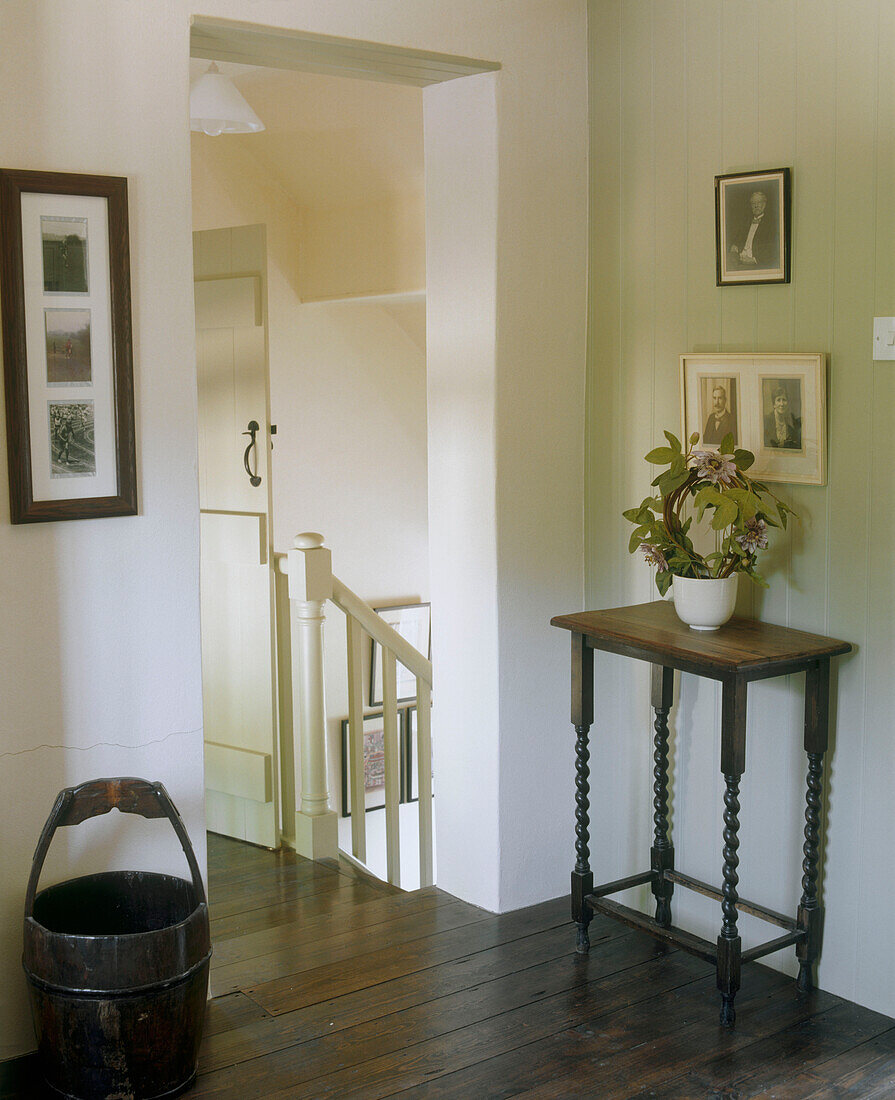 Country style hallway with wooden floor at the top of a staircase landing