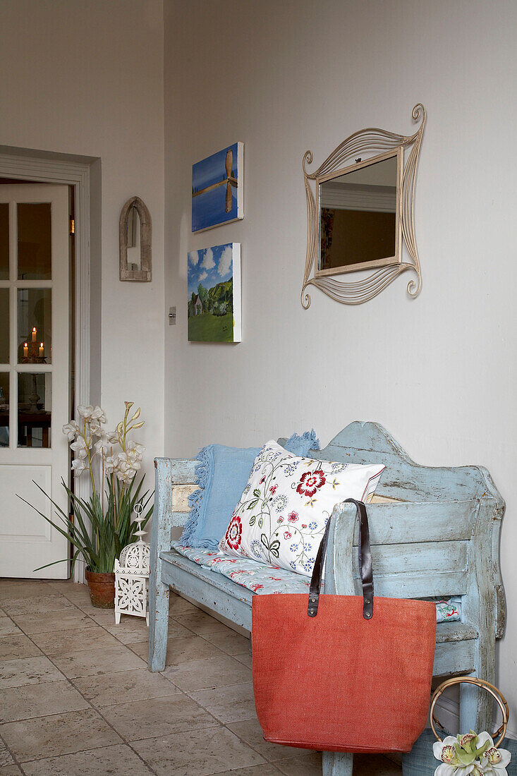Mirror above salvaged bench with shopping bag in Arundel, West Sussex