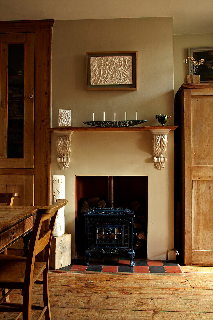 Wood burning stove in recessed fireplace of Brighton dining room, UK