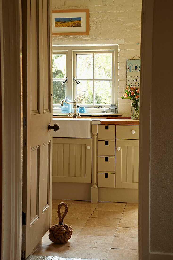 View through doorway to kitchen of West Sussex home, England, UK