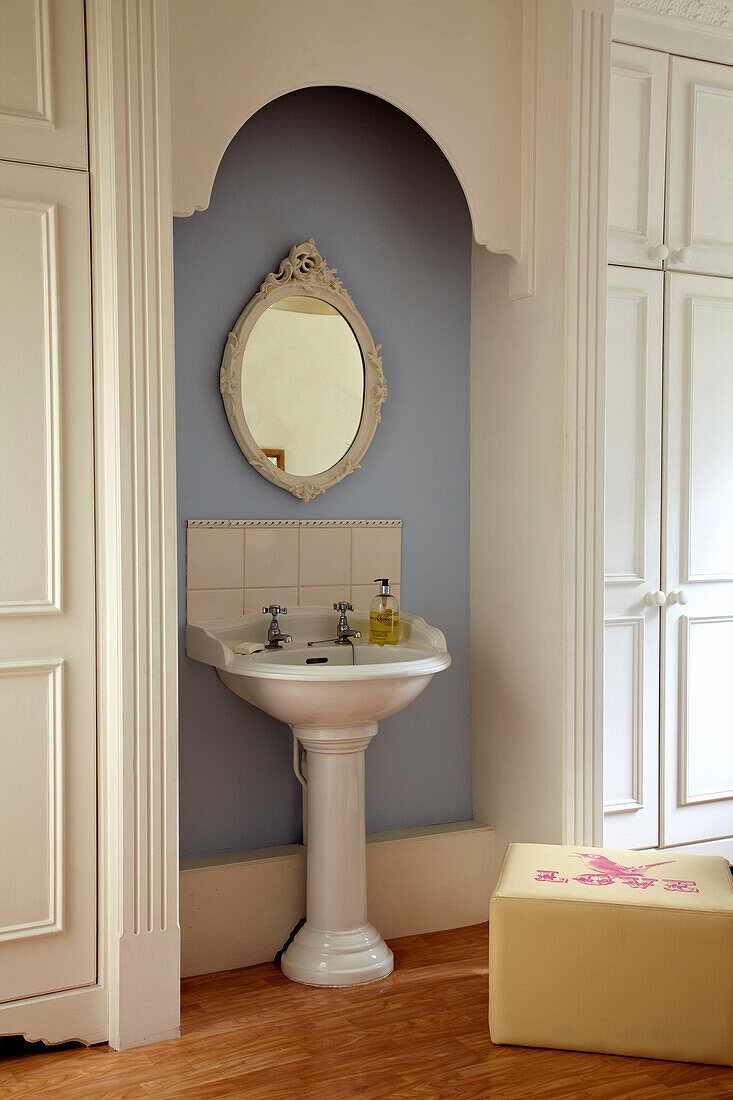 Recessed pedestal base wash basin in bathroom of Brighton townhouse, Sussex, England, UK