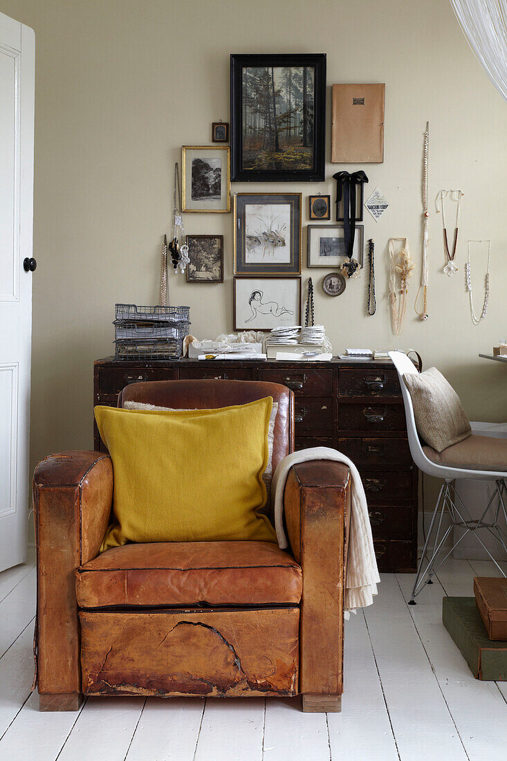 Battered leather armchair in study of London home
