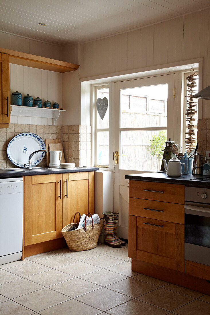 Wood fitted units in kitchen of Norfolk beach house, UK