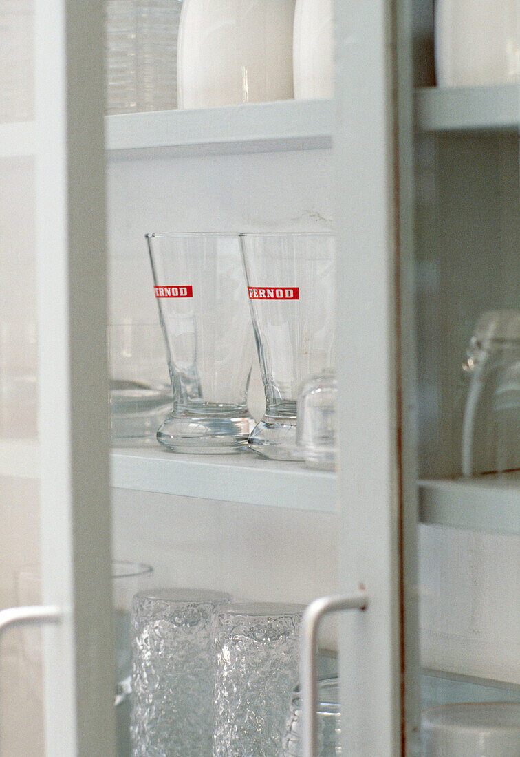 Close up detail of glasses in the glass fronted cabinet