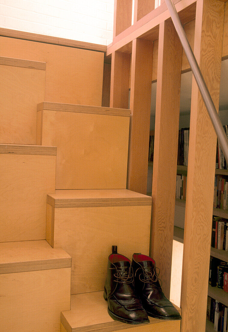 Detail of a modern shelving unit with a pair of smart shoes at the bottom
