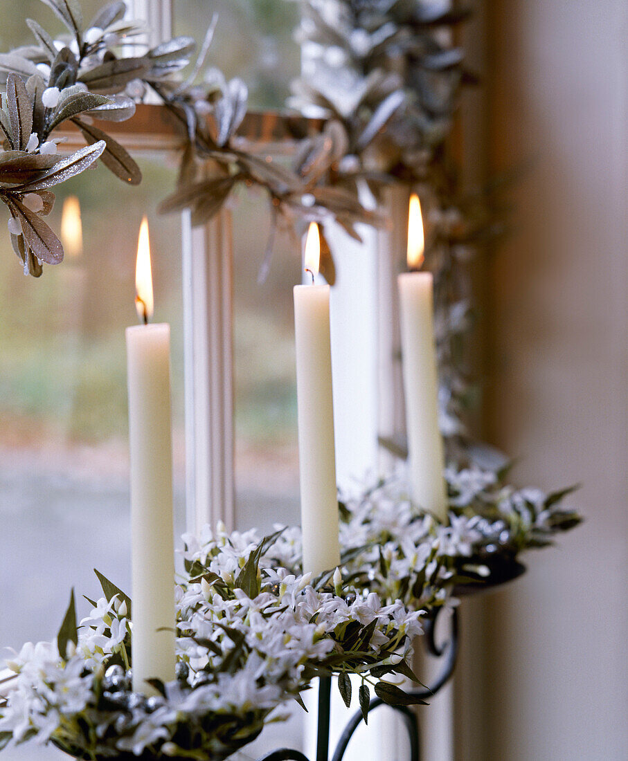 Christmas decorations of mistletoe and lit candles